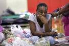 New Orleans resident Eileen Glenn, 26, is grief-stricken at a Red Cross shelter in San Antonio, Wednesday, Aug. 31, 2005. Glenn and her four children were able to escape the disaster in New Orleans but left behind her mother and other relatives. (AP Photo/San Antonio Express-News, Jerry Lara)