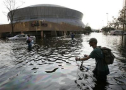 A man pushes his bicycle through flood waters near the Superdome in New Orleans, Wednesday, Aug. 31, 2005. Hurricane Katrina left much of the city under water. Officials called for a mandatory evacuation of the city, but many resident remained in the city and had to be rescued from flooded homes and hotels. (AP Photo/Eric Gay)